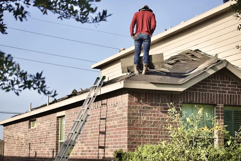 Professional roofer working on a residential roof in North Garrison Heights